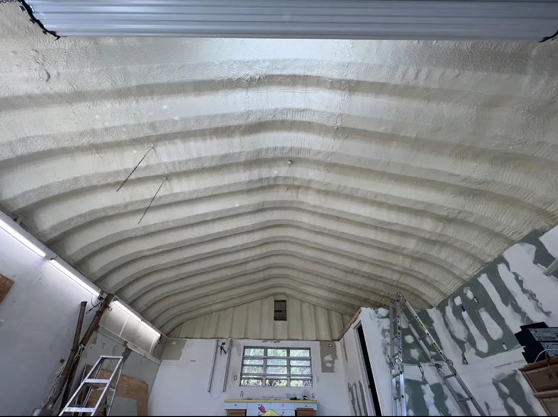 Spray polyurethane foam applied to the underside of a metal roof deck in Arlington